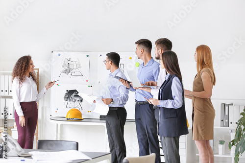 Architect teaching young pe...