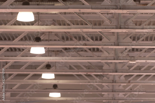 Ceiling in the hangar. The lights on the ceiling in a large room. White high ceilings.