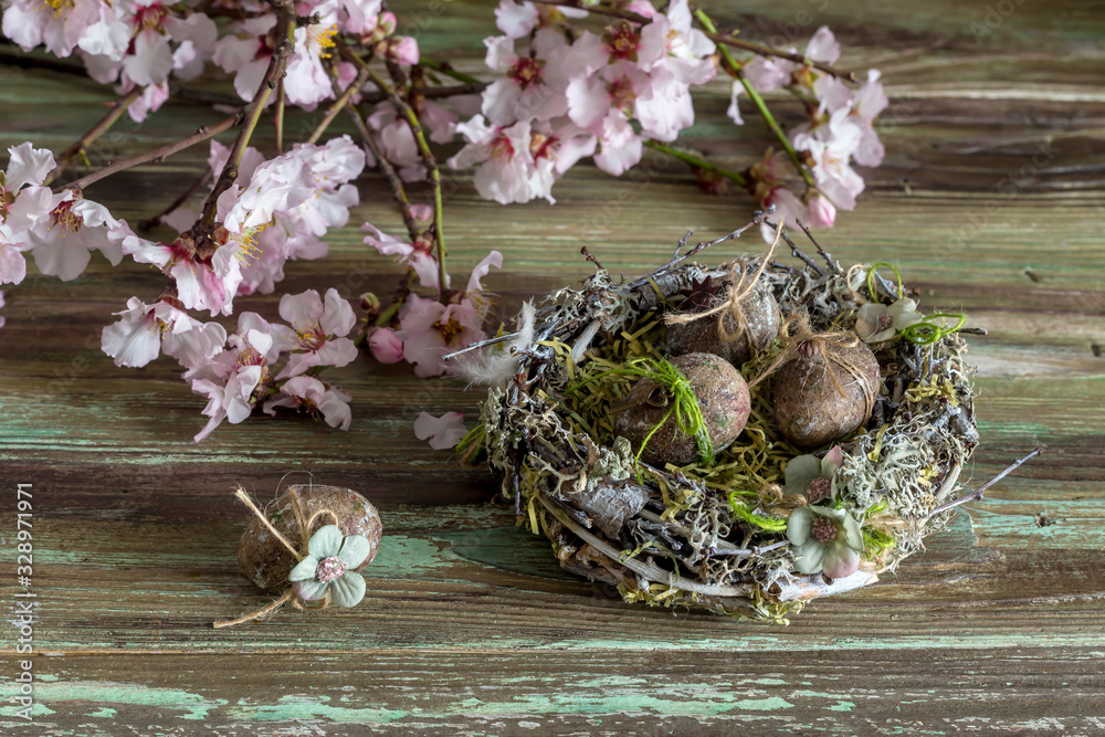 Easter composition with almond branches, nest and eggs Easter composition with almond branches, nest and eggs