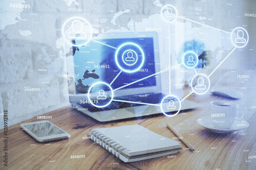 Computer on desktop with social network hologram. Multi exposure. Concept of international people connections. Computer on desktop with social network hologram. Multi exposure. Concept of international people connections.