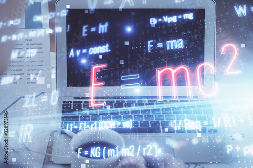 Desktop computer background and formula hologram writing. Double exposure. Education concept. © peshkova