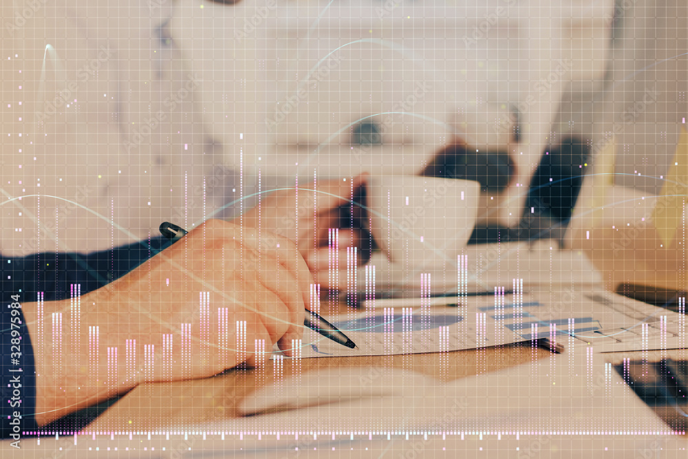 Double exposure of man's hands writing notes of stock market with forex graph. Double exposure of man's hands writing notes of stock market with forex graph.