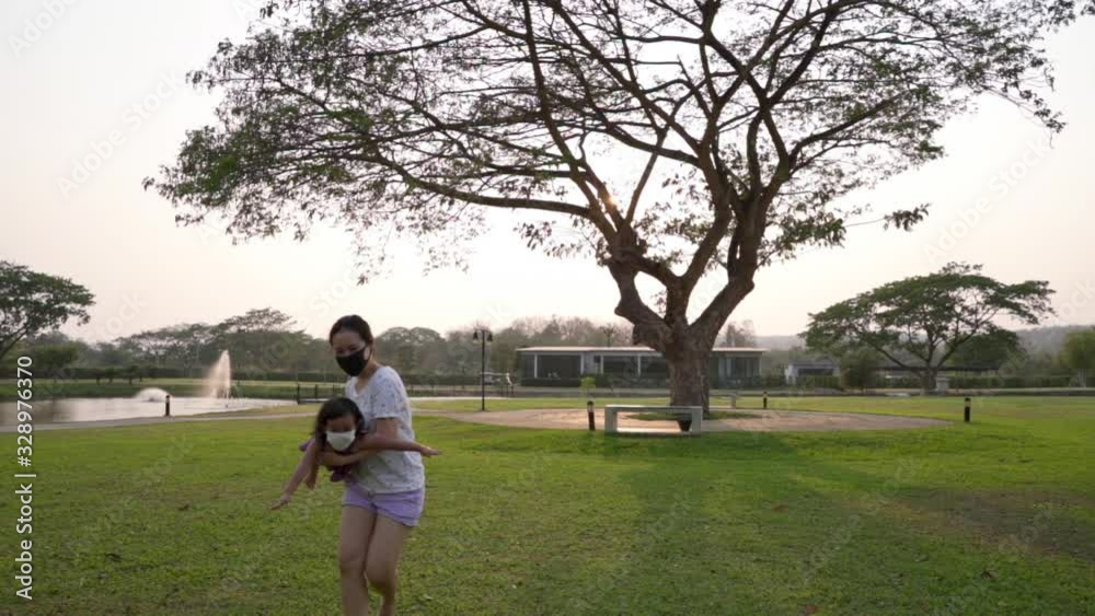 Mother and daughter playing at park during sunset hour. Slow motion Mother and daughter playing at park during sunset hour. Slow motion