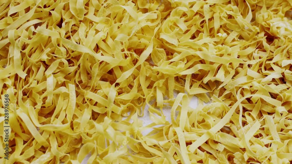 Homemade noodles drying on a table Homemade noodles drying on a table