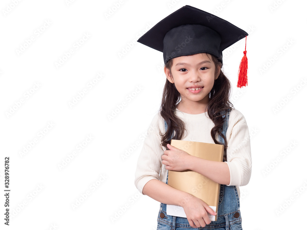 Asian little cute girl 6 years old wearing graduation hat and holding a book on hands. Preschool lovely kid with a book. Asian little cute girl 6 years old wearing graduation hat and holding a book on hands. Preschool lovely kid with a book.