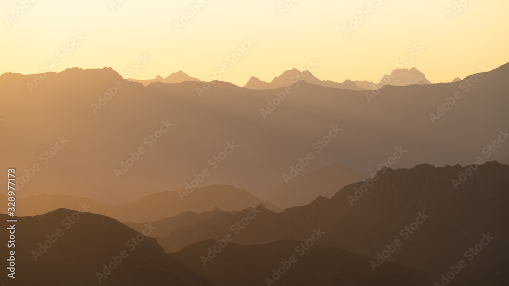 Mountains layers in new zealand. Sunset over the mountains with an orange sky