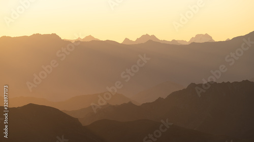 Mountains layers in new zealand. Sunset over the mountains with an orange sky