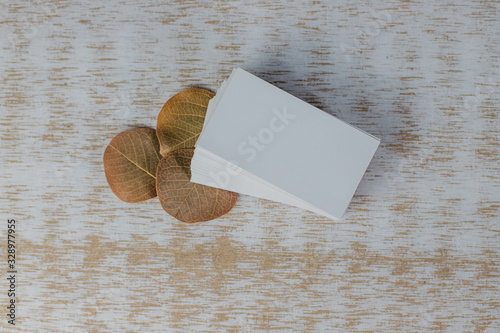 Business card mockup on light background. Corporate stationery set mockup. Business card stack on wooden background. Business card template. Top View.
