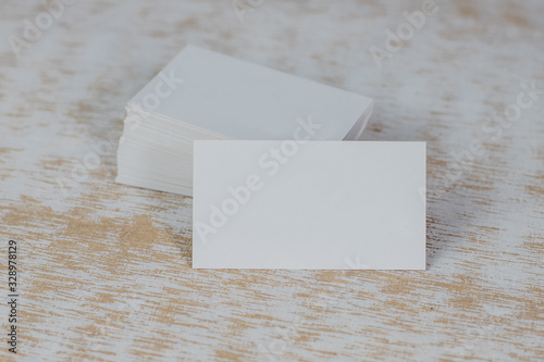 Business card mockup on light background. Corporate stationery set mockup. Business card stack on wooden background. Business card template. Top View and front view.