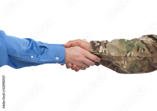 US Army soldier shaking the hand of a civilian businessman at a job interview that hires veterans.