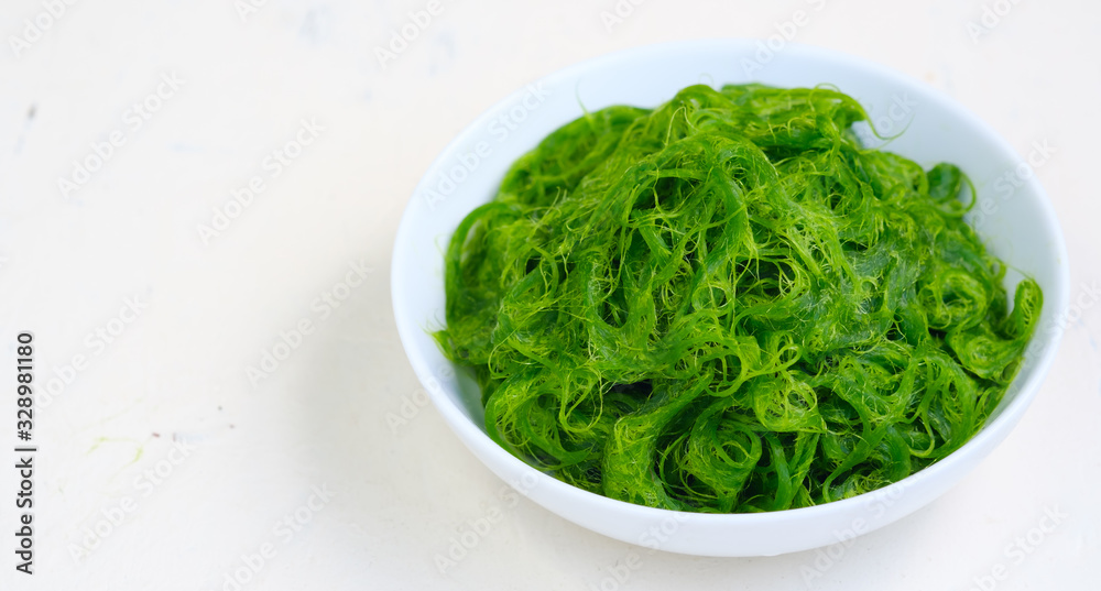 Fresh Algae in bowl on white backdrop.copy space .asia food.natural food Fresh Algae in bowl on white backdrop.copy space .asia food.natural food
