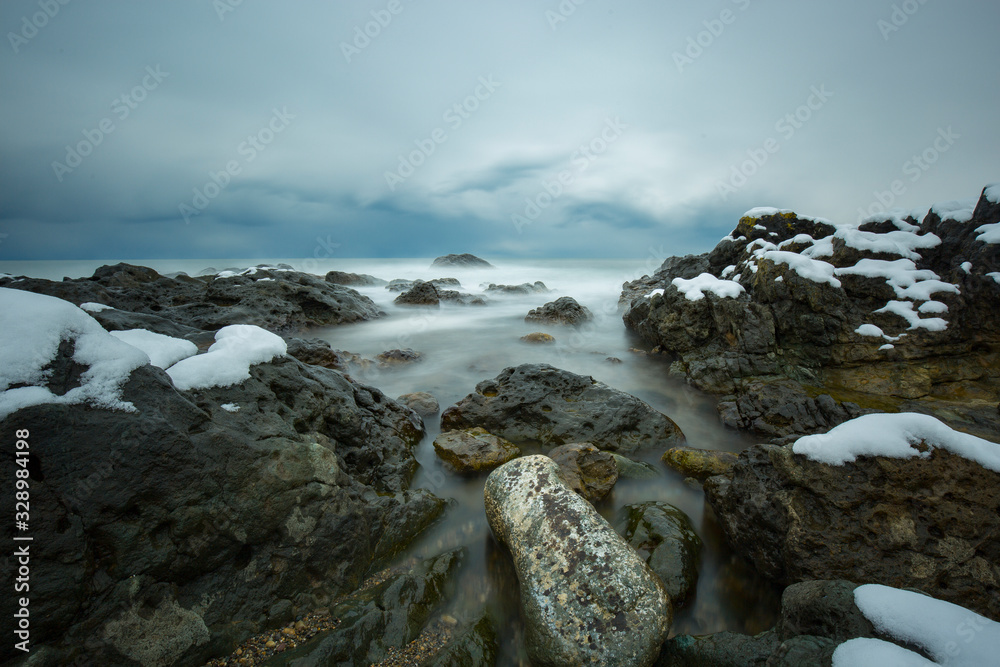 long exposure of rocky and seascape at sunset long exposure of rocky and seascape at sunset
