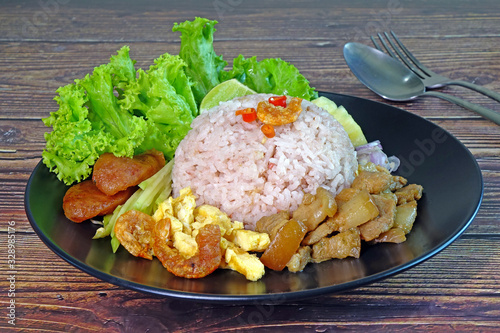 Fried rice with shrimp paste (Khao khluk Kapi), a flavorful dish in Thai cuisine that consists of primary ingredients of fried rice mixed with shrimp paste (Kapi) and variety of vegetables. photo