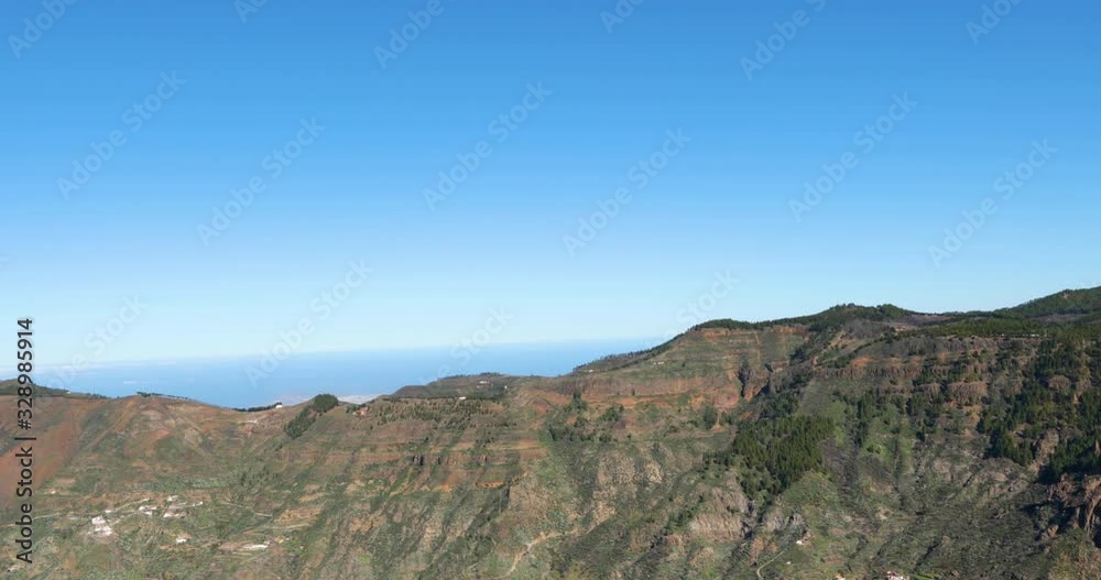 Rocks in national park with lots of trees overlooking horizon to ocean Canary island 4k slow motion capture at 60fps