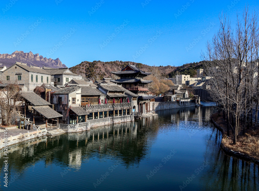 Traditional building next to a river in China near Beijing. A tourist destination in front of the great wall of China.