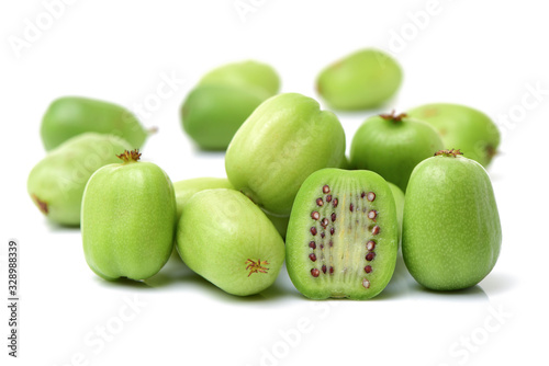 mini kiwi baby fruit (actinidia arguta) on white background 