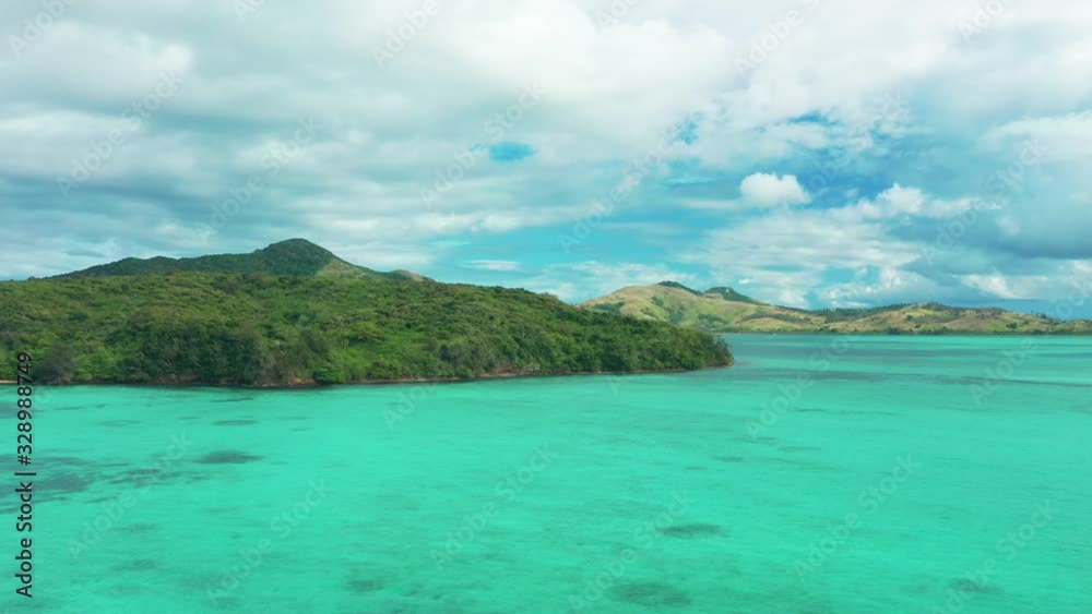 The beautiful green Fiji Islands on a bright summer day, the perfect getaway - aerial The beautiful green Fiji Islands on a bright summer day, the perfect getaway - aerial