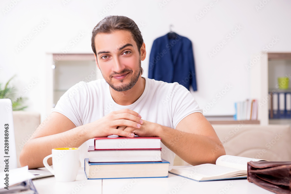 Young male student preparing for exams at home Young male student preparing for exams at home