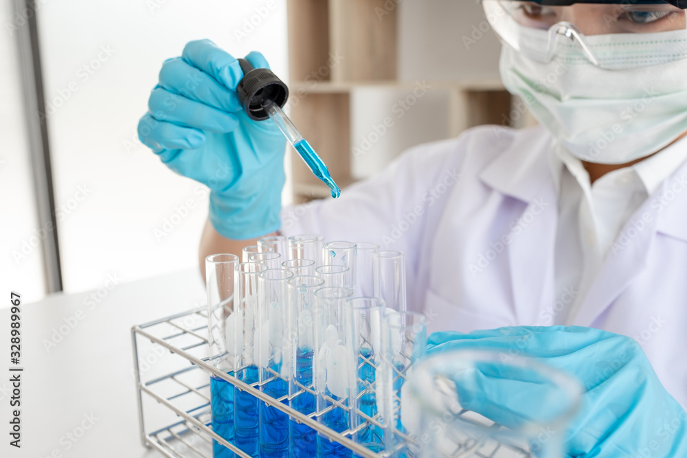 Medical scientists released a sample pipette into a test tube to analyze the virus in a chemical laboratory. Scientific research concepts Medical scientists released a sample pipette into a test tube to analyze the virus in a chemical laboratory. Scientific research concepts