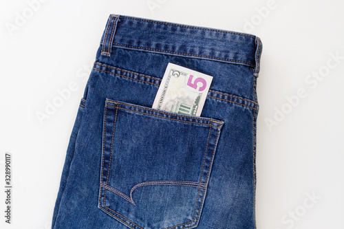 jeans with pocket money dollars on a white background