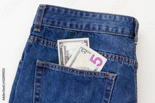 5 dollars in jeans pocket on a white background