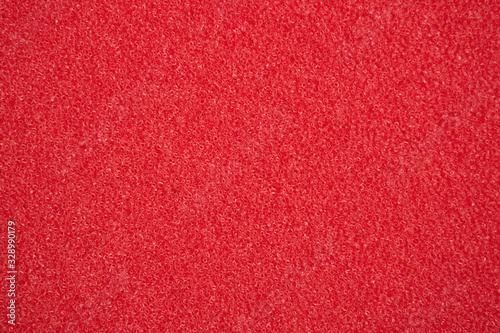 Abstract red background. Porous surface, sponge. Texture.