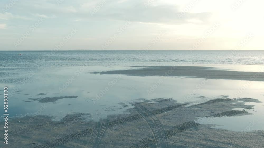 Back Crawl of the bay, sunset and tire tracks in the sand. Back Crawl of the bay, sunset and tire tracks in the sand.