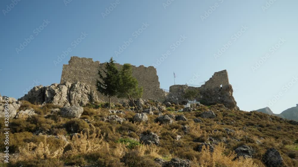 Low angle view of Archangelos Fort Castle on top of the hill, Rhodes Island, Greece Low angle view of Archangelos Fort Castle on top of the hill, Rhodes Island, Greece