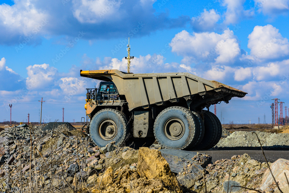 Obraz premium Huge empty dump truck on a gravel road