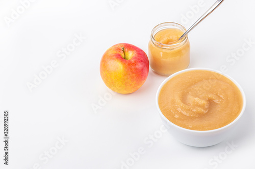 Quadro em tela Fresh homemade applesauce in white bowl and jar with fruit puree on white table
