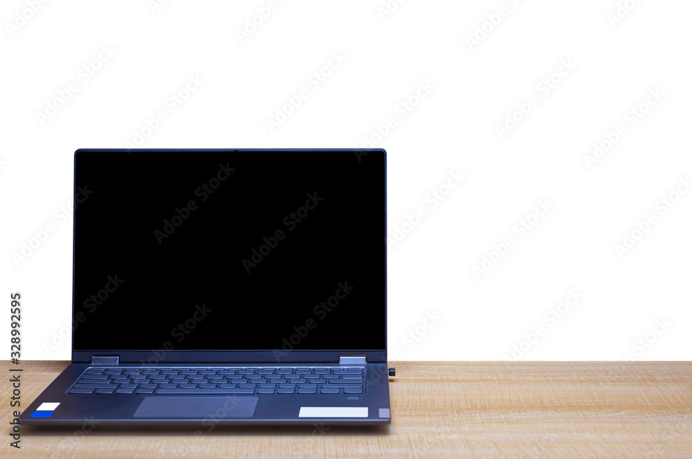 A notebook computer placed on a wooden office desk and isolated on white background with clipping path A notebook computer placed on a wooden office desk and isolated on white background with clipping path
