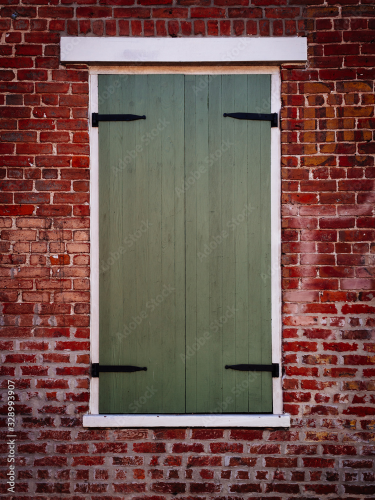 Wooden Window Shutter on Brick Building Wooden Window Shutter on Brick Building