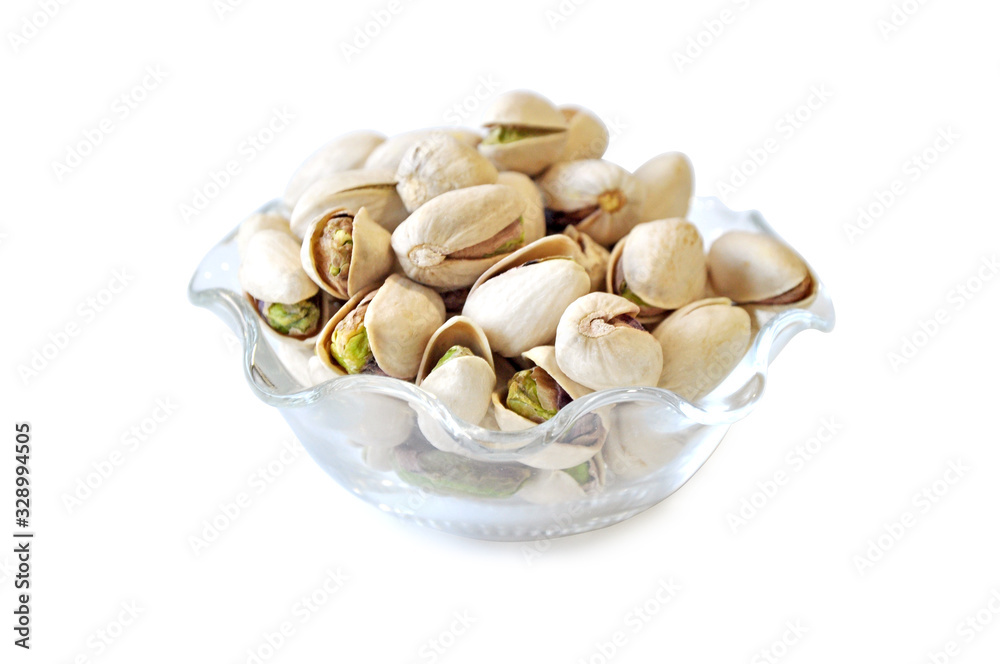 Pistachio in glass bowl white background Pistachio in glass bowl white background