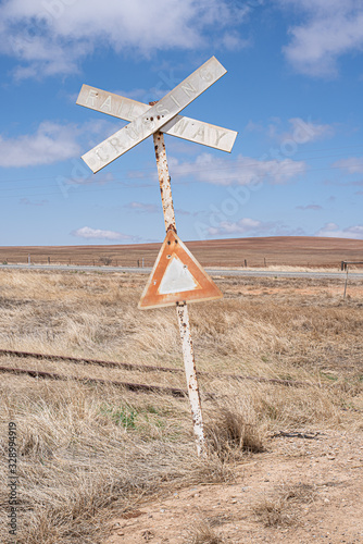Obraz na plátně Faded vintage Railway Crossing sign with Bullet holes
