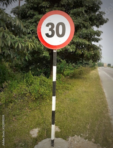 Speed limit 30 sign at the highway. Round speed limit thirty warning plate