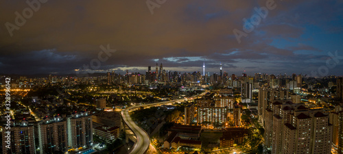 Aerial Panoramic view of Kuala Lumpur with rain clouds during night time.