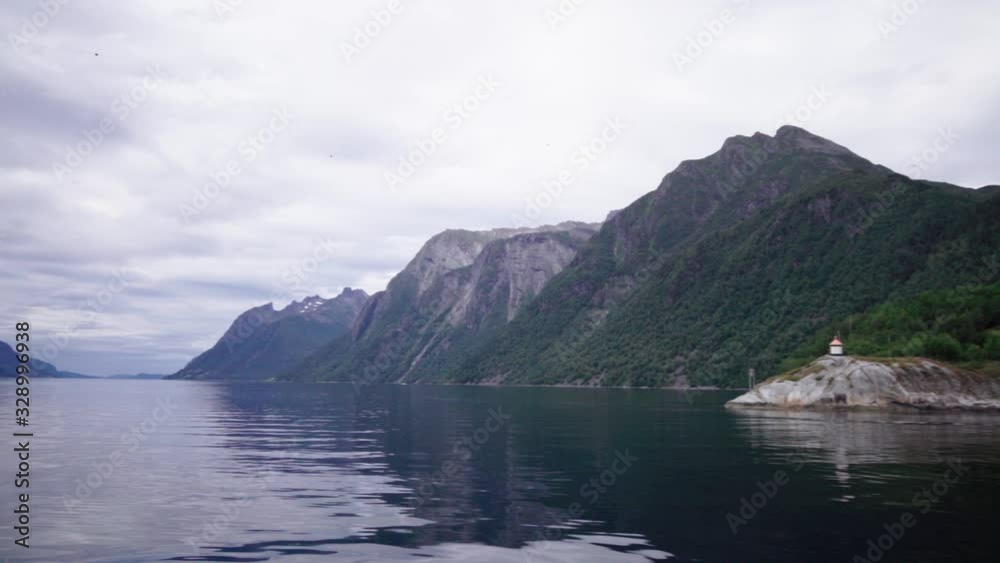 view down the breathtaking fjord from a ferry boat in the norwegian sumørsalpene - magnificent scenery on a cloudy day view down the breathtaking fjord from a ferry boat in the norwegian sumørsalpene - magnificent scenery on a cloudy day