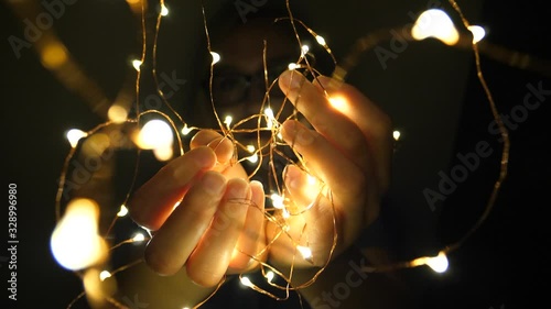 Close Up of Female Hands Holding Fairy Led String Light Garland, Selective Focus Close Up photo