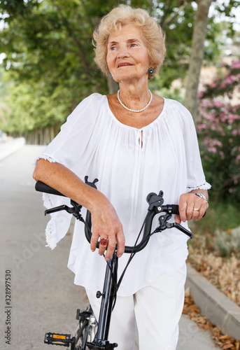 Senior woman resting near bike © JackF