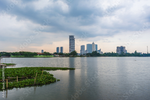 Tangerang, Indonesia - 5th January 2018: A view of Danau Kelapa Dua (Kelapa Dua Lake) on the foreground and Lippo Karawaci district buildings in the background. Taken in a cloudy afternoon.