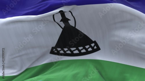 4k Lesotho National flag slow loop seamless waving with visible wrinkles in wind blue sky background.A fully digital rendering;animation loops at 20 seconds. photo