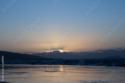 Sunset on aegina island in greece with clouds