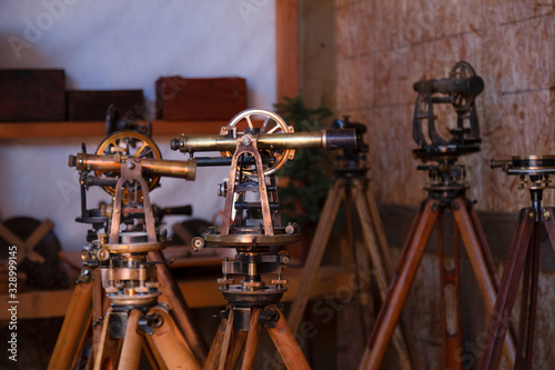 Cuadro en lienzo Two antique surveyors sextants on wooden tripods in workroom environment with tr