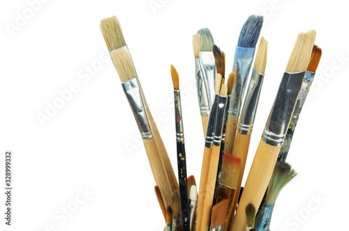 Set of various professional paint brushes in the jar