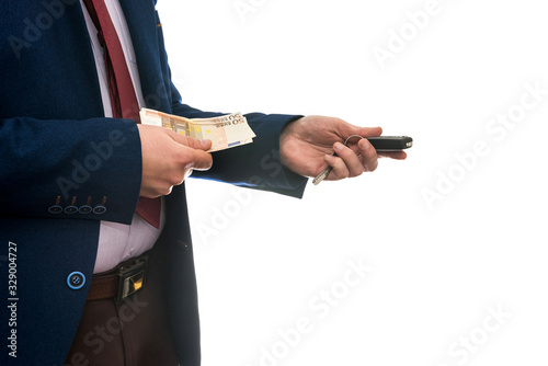 businessman holding euro banknotes and car keys isolated on white background closeup. Buy or rent car concept.