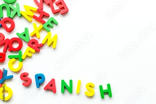 Learn Spanish. Concept with letters on white background top-down copy space