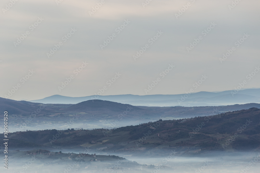Sea of fog and mist between layers of mountains and hills