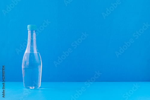 bottle of water on blue background.