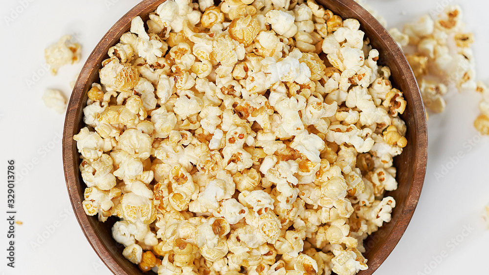 photo sweet popcorn on a white background wooden bowl top view photo sweet popcorn on a white background wooden bowl top view