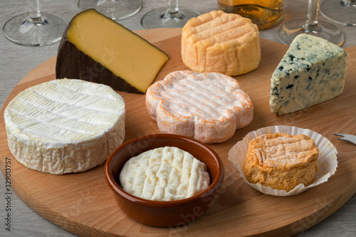 Wooden cheese board with a variety of cheeses
